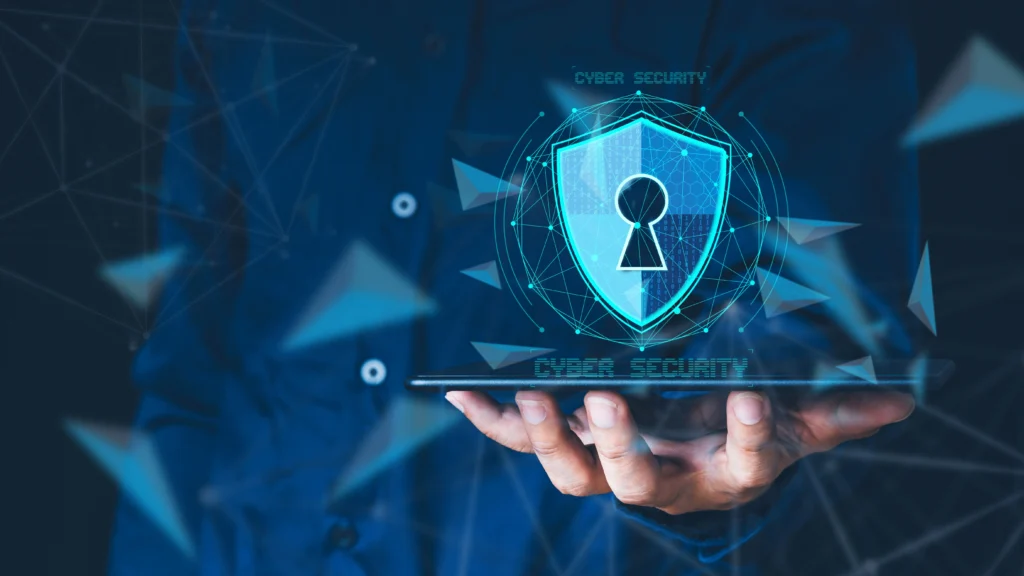 A person holding a tablet featuring a glowing digital shield, representing Cyber Security Services in wellington