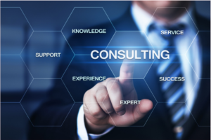 A businessman pointing at a digital consulting graphic with business keywords.