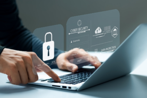 Hands typing on a laptop with a digital overlay showing cybersecurity login and padlock.